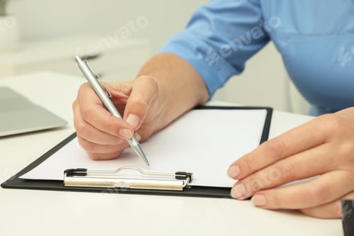 Preview: Woman Writing on Clipboard in a Medical Setting