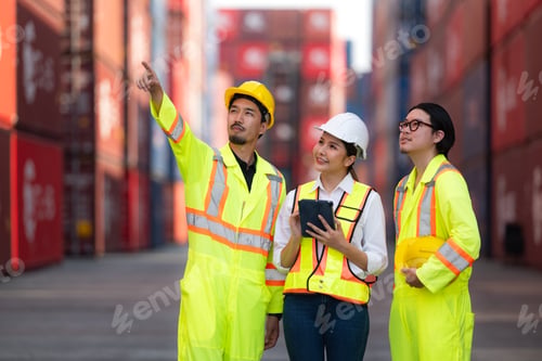 Preview: Group of engineers working with laptop in the container yard.