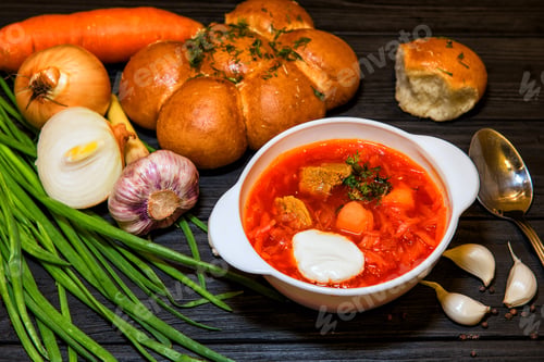 Preview: A bowl of borscht garnished with dill and a dollop of smetana (sour cream)