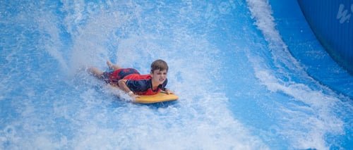 Preview: Closeup of a boy surfing on the swimming board in the aquapark