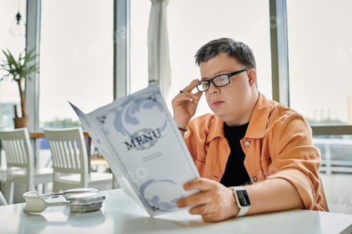 Preview: Man with down syndrome choosing meal at cafe