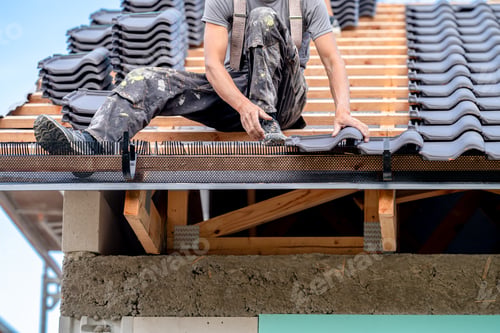 Preview: construction work on the roof of a family house, fired ceramic tiles on wooden beams