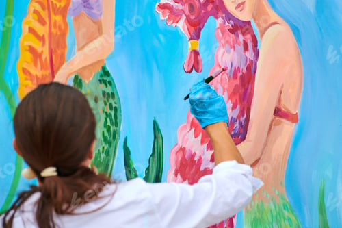 Preview: Woman painting with acrylic paints modern drawing using paint brush, outdoor art festival