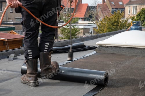 Preview: Roofer Using Propane Torch to Install Roll Roofing on Flat Residential Roof for Repair