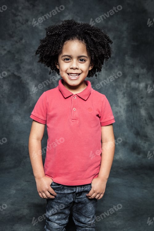 Preview: A mulatto boy with curly hair and a red T-shirt smiles at the camera.