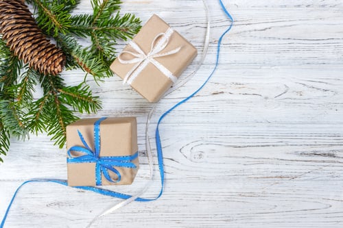 Preview: Christmas gift box on the white wooden table background,spruce branch,pine cones,