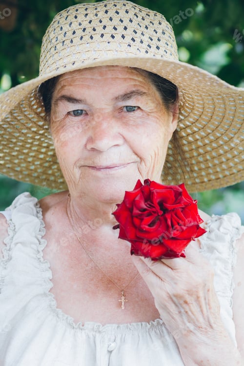 Preview: Portrait Of An Elderly Woman With A Red Rose. Toning. Selective Focus.