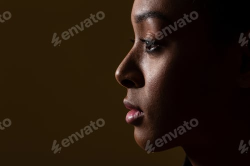 Preview: Side view of young woman on black background