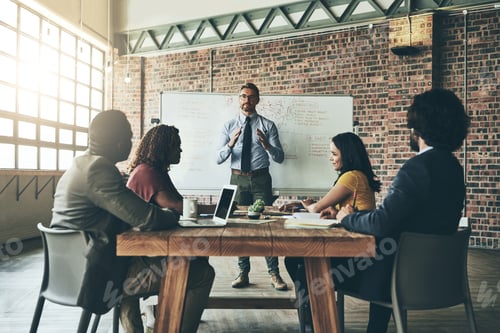 Preview: Shot of a well-dressed businessman giving a presentation to his colleagues in the office