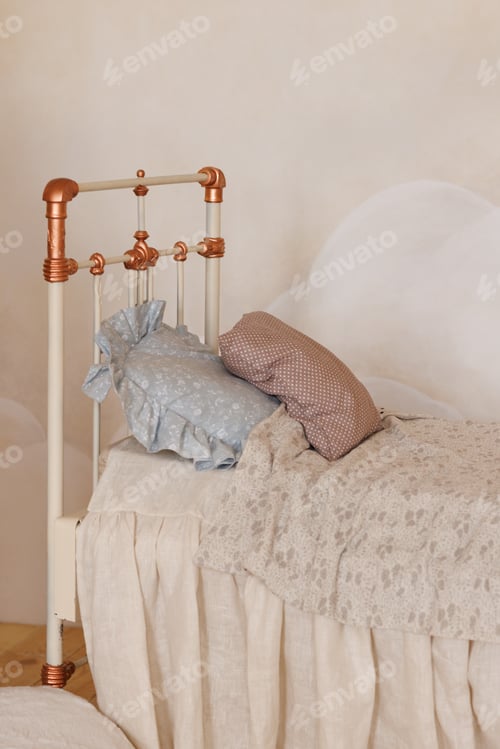 Preview: A bed with a white headboard and a blue pillow
