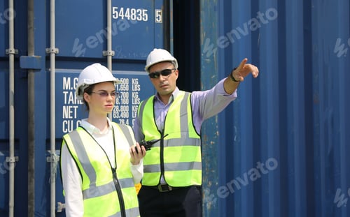 Preview: Foreman control loading Containers box from Cargo freight ship for import export.