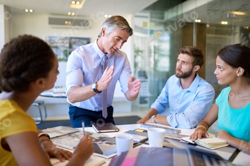 Preview: We need to condense these tasks. Shot of a group of coworkers in a business meeting.