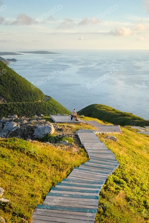 Preview: Man on wooden steps by sea, Cape Breton, Nova Scotia, Canada