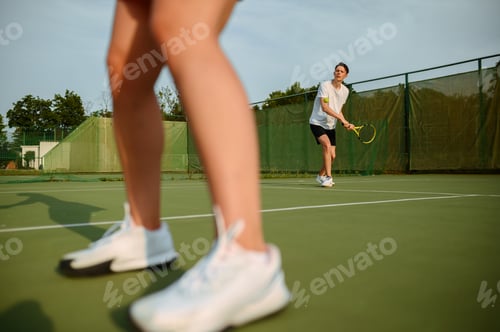 Preview: Man and woman on tennis training, outdoor court