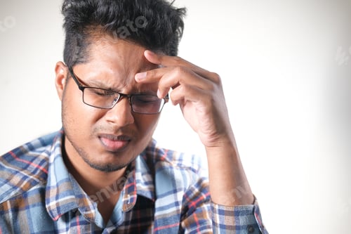 Preview: Young man suffering headache, close up
