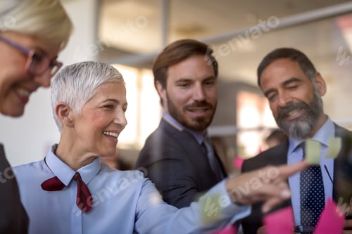 Preview: Group of happy young business people in a meeting at office
