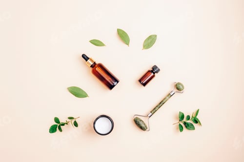 Preview: Modern apothecary, natural ingredients. Cosmetic serum, cream, facial roller and essential oil.