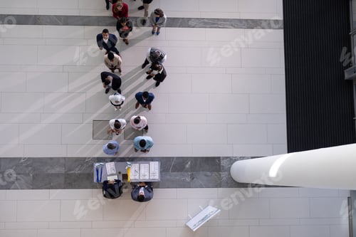 Preview: High angle view of multi-ethic group business people standing in queue at office