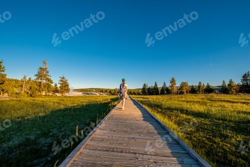 Preview: Tourist with backpack hiking in Yellowstone