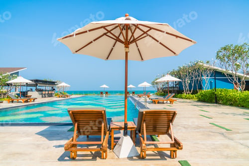 Preview: Beautiful umbrella and chair around swimming pool in hotel and r