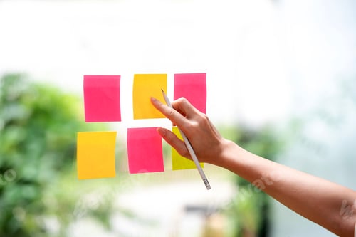 Preview: Close-up of woman hand holding a pencil with a note paper on the mirror.