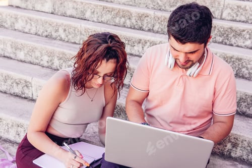 Preview: College students studying on the stairs in the library