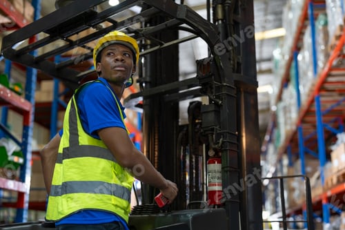 Preview: Black man employee driving forklift unload and moving goods for retail warehouse shipping.