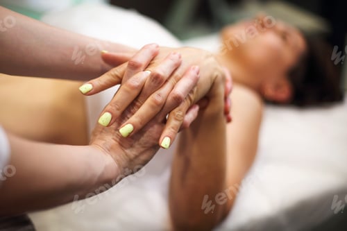 Preview: Woman masseur giving hand massage to client