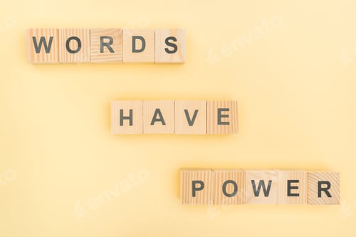 Preview: top view of phrase words have power lettering with wooden cubes on yellow background