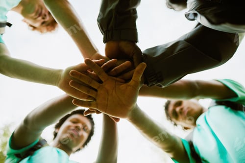 Preview: Diverse Teenagers Stacking Hands in Teamwork Gesture Outdoors