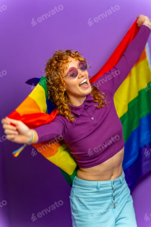 Preview: Lesbian woman dancing with lgbt rainbow flag