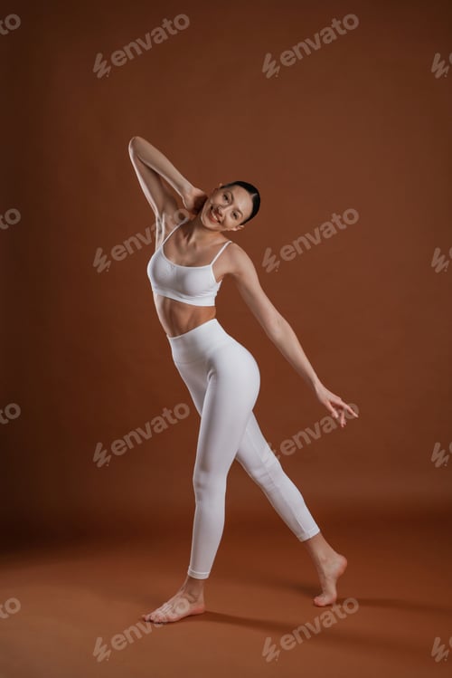 Preview: Female, front view, smiling. Beautiful fitness woman is in the studio