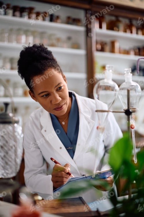 Preview: Black female scientist working in a pharmacy.