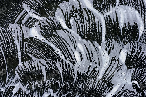 Preview: background with white soap foam on black surface