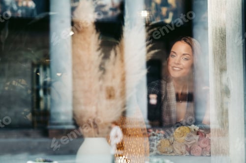 Preview: Portrait of a young European girl with long hair in a cafe sitting near the window, a tall girl in a