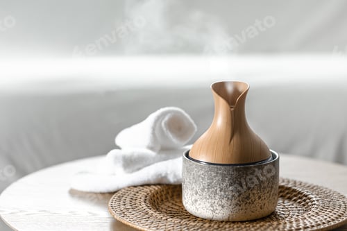 Preview: Essential oil aroma diffuser humidifier diffusing water in the air.