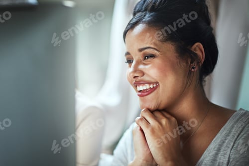 Preview: Shot of a happy young businesswoman looking at her computer screen while sitting in the office