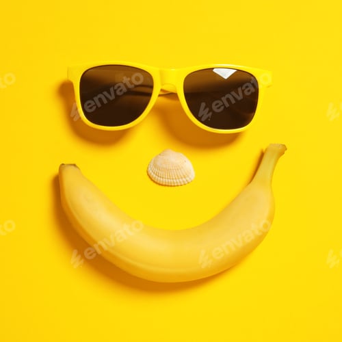 Preview: Funny face of sunglasses, banana and seashell on color background, top view. Beach accessories