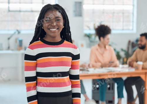 Preview: Young cheerful african american businesswoman standing in an office. Confident black female manager