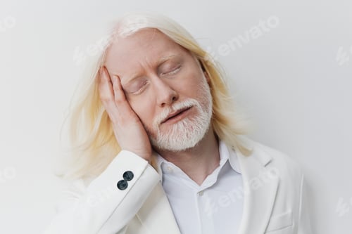 Preview: Portrait of a calm man with white hair and beard, posing with a serene expression against a light