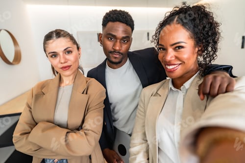 Preview: Business team taking selfie in modern office