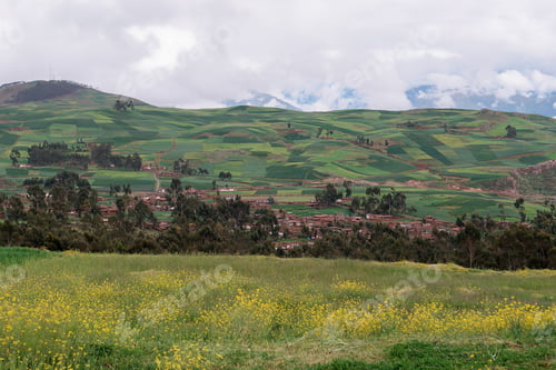 Preview: Small village nestled in a colorful valley of the andes mountains is surrounded by a patchwork