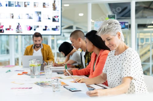 Preview: Side view of diverse business people discussing in the meeting at conference room in office