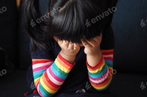 Preview: a upset child girl cover her face with hand