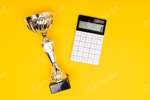 Preview: Gold Cup and Calculator on yellow background