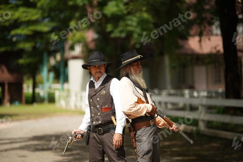 Preview: Brutal cowboy with revolver, gunfight on ranch, rural background.