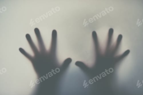 Preview: Defocussed shot of a pair of hands reaching out against a plain background