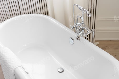 Preview: Shiny Metal Chrome Faucet, Elegant Water Tap On White Freestanding Bathtub In Bathroom