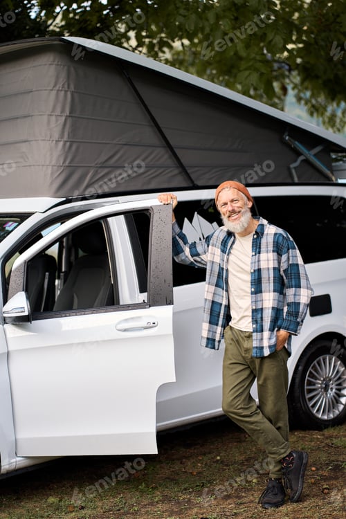 Preview: Happy older man traveler standing with camper van, campervan rentals.