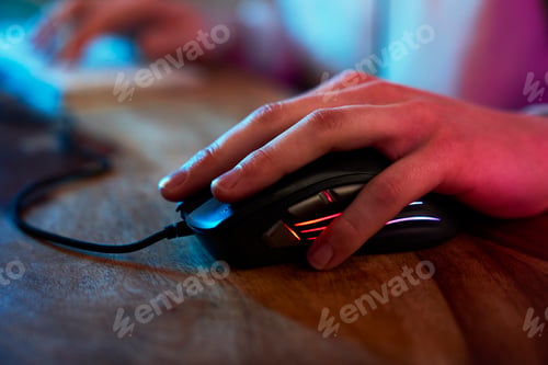 Preview: Detail of computer mouse used by gamer at night